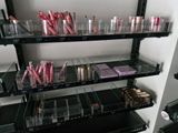 a lot of makeup products on the shelves in the room