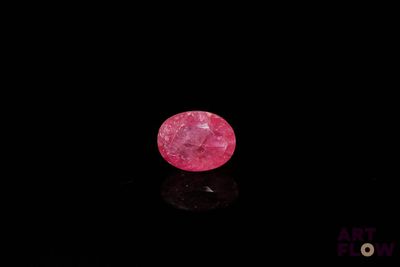 a pink diamond on a black surface