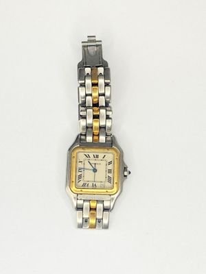a close up of a wrist watch on a white surface