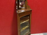 a small wooden cabinet with a mirror on top of it