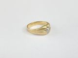 a gold ring with a diamond on top of it