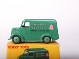 a green toy truck sitting on top of a yellow box