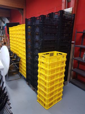 a room with a lot of crates and chairs
