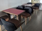 several chairs and tables are lined up in a row in a room