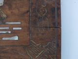 a piece of wood with a carving of a bird on it