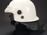an old white helmet with a vise on a black stand