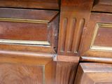 a close up of a wooden cabinet with a hole in it