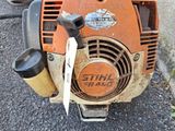 a close up of a chainsaw with a tag attached to it