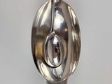two spoons hanging from a hook on a wall