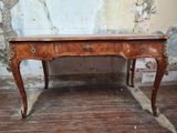 a wooden desk with a marble top on a wooden floor