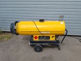 a yellow proprigerator sitting on a cart in front of a garage