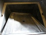 an image of a metal sink in a dirty room