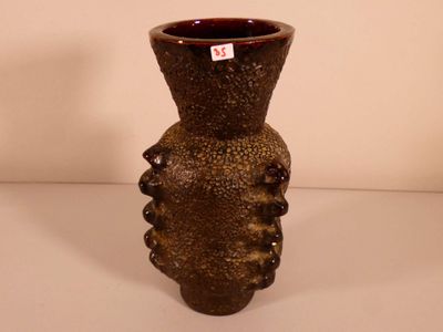 a brown vase that is sitting on a table