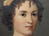 portrait of a woman in a yellow hat by a painting