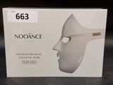 a box with a white mask on it on a table