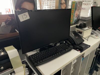 a desk with a computer monitor and keyboard on it