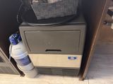 a cooler and a water bottle in a small room
