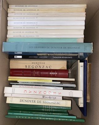 a box full of books that are stacked on top of each other