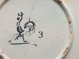 a white plate with a drawing of a rooster on it