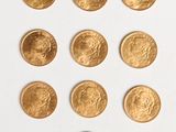several gold coins are arranged in a circle on a white surface