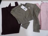 three pairs of women ' s clothing on a table with a price tag
