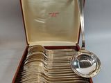 a box with a set of silver spoons in it