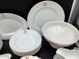 a lot of plates and bowls that are sitting on a table