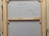 an old picture frame with a message written on it in a room