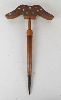 an image of a wooden hammer with colorful dots on it