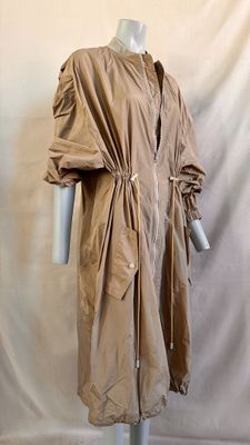 an image of a mannequin dressed in a trench coat