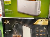 several boxes of different types of toasters are stacked on top of each other