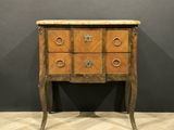 an antique chest of drawers with a marble top on a wooden floor