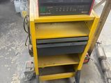 a yellow cart that has some tools on top of it