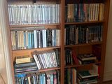 a bookshelf with many books on it in a room