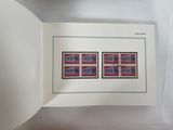 an open book with a picture of a pair of stamps on it
