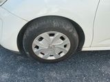 a white car that is parked on the side of the road