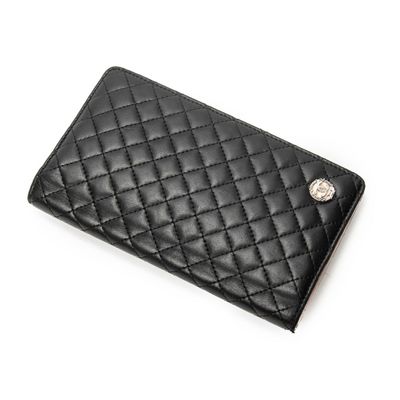 a black quilted wallet with a metal button on the front