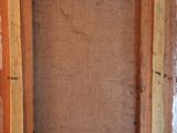 an old picture frame sitting on top of a wooden table