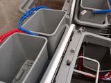 four buckets sitting on top of each other on the back of a truck