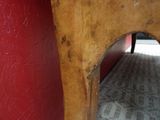 a wooden table with a red wall in the background