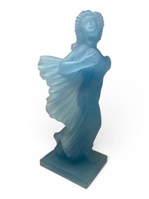 a close up of a statue of a woman with a blue dress on a white background