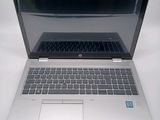 a laptop computer sitting on top of a white table