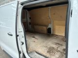 a white van with the door open in a garage