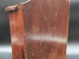 a small wooden magazine holder with a heart on it