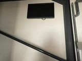 a television mounted on the wall in the bathroom