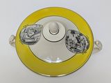 a yellow and white plate with a black and white picture on it