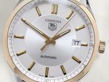 a close up of a watch with a white face
