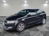 the black volkswagen polo estate is parked in the garage