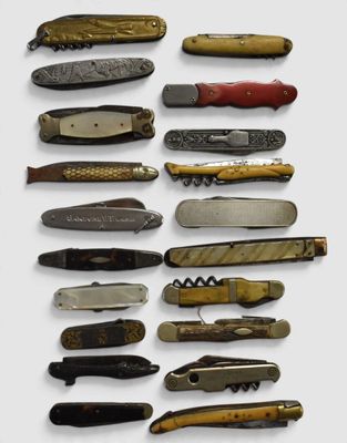 many different types of pocket knives on a white surface