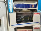three boxes of miniature trains are stacked on top of each other